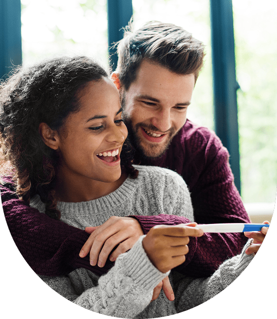 Couple happily shopping online together on a laptop.
